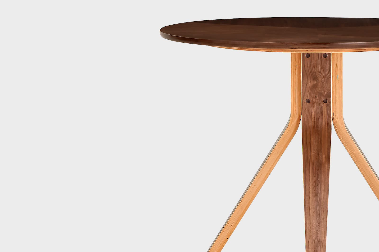 Radar wooden pedestal table by Wales&Wales, showing the curved base and underside of the round top