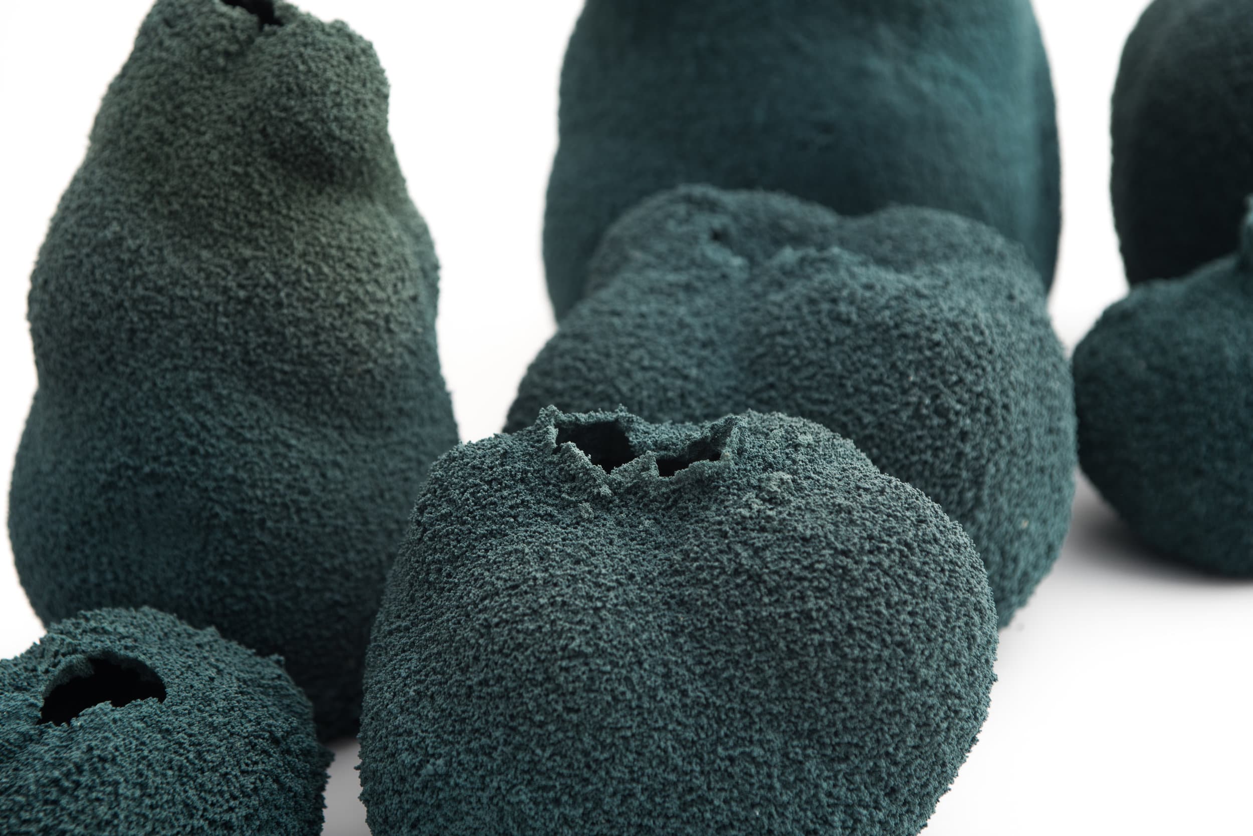An elevated close view of Michal Fargo’s teal Else Coral porcelain vessels