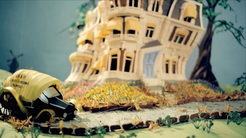 The Move — current paper-animation poster showing a model house and van