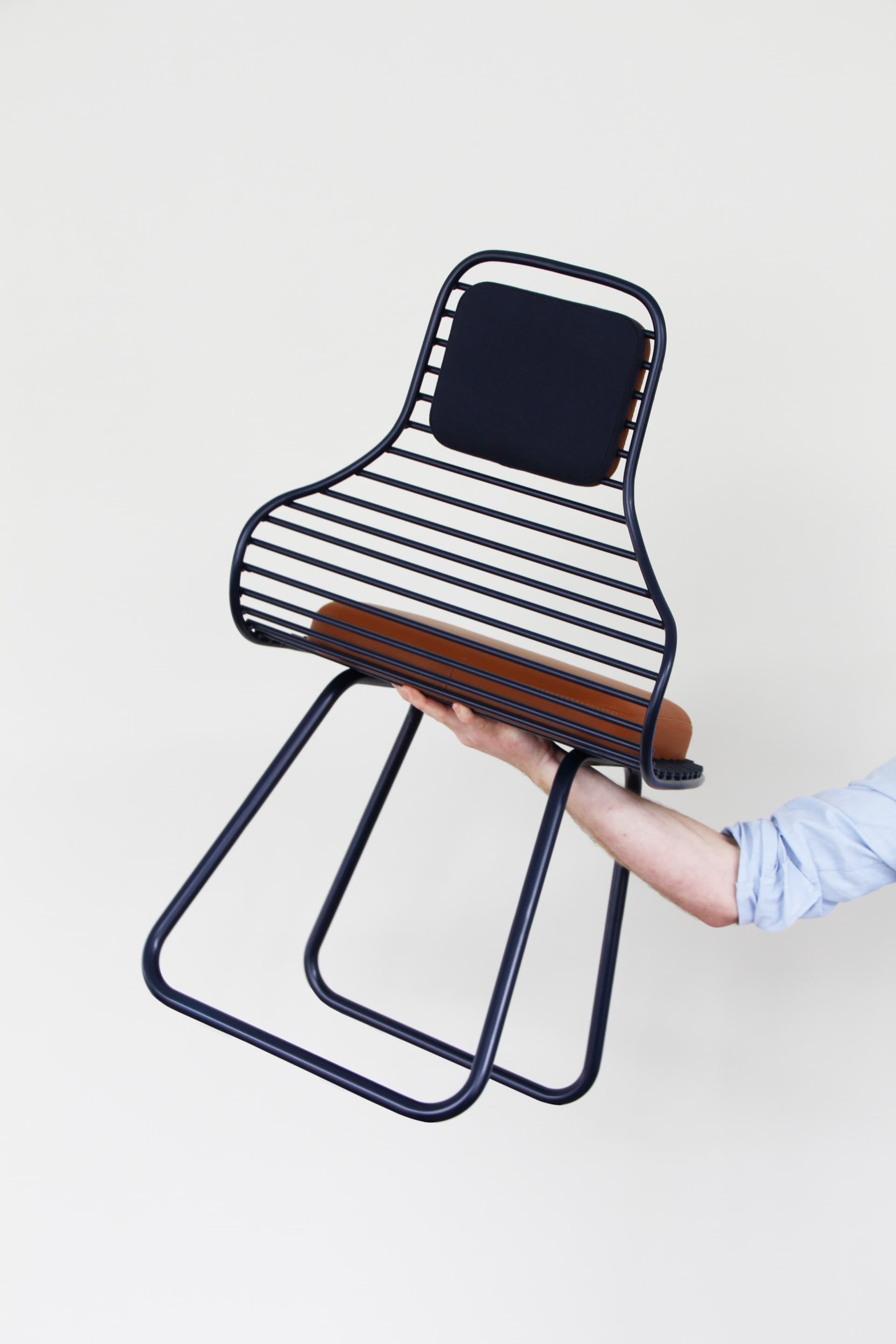 Rear view of Chair 01 by Daphna Laurens for Wittmann, showing its open grid and bent tubular supports