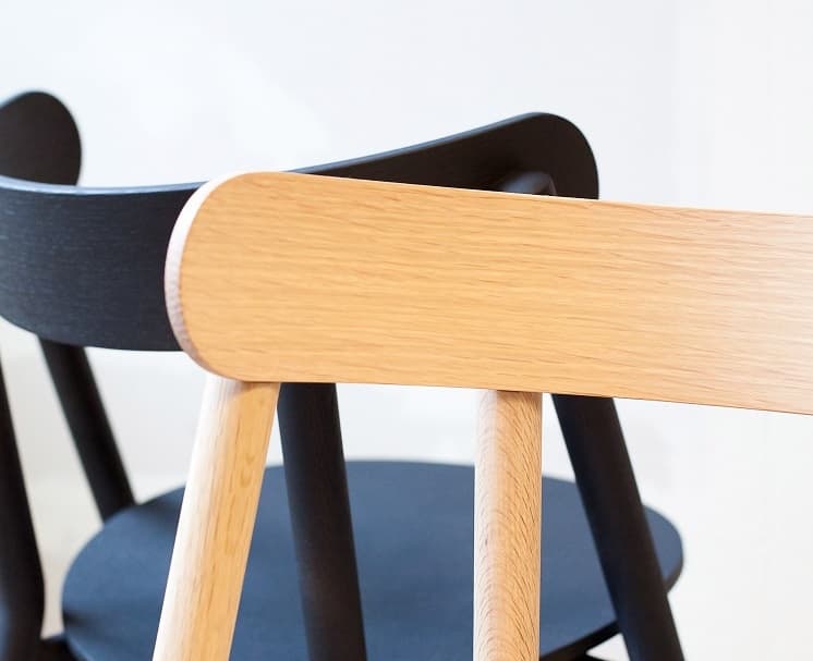 Detail of the natural-oak and black Oki chair backs and supports