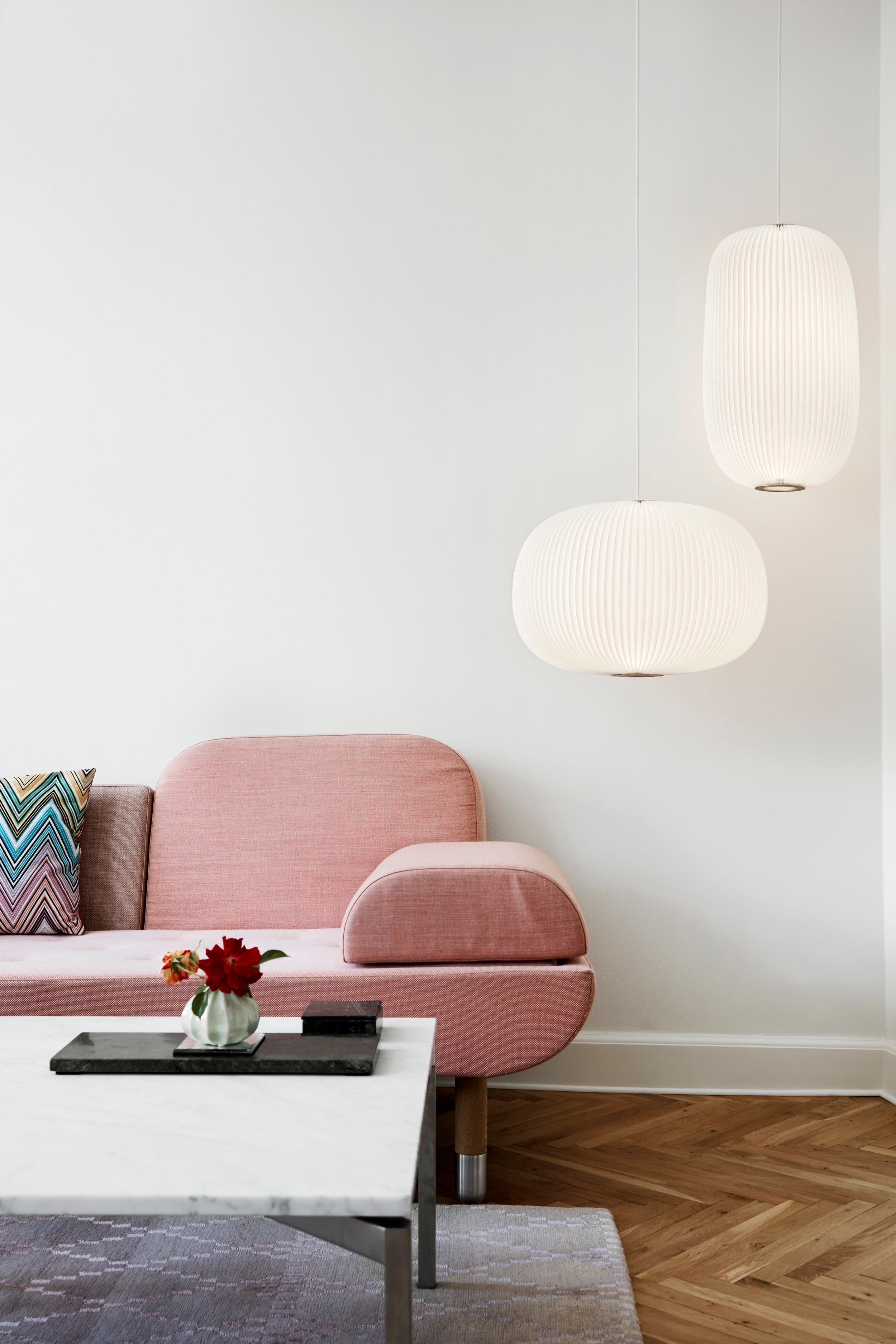 Lamella (2017) — two pleated pendant forms above a sofa