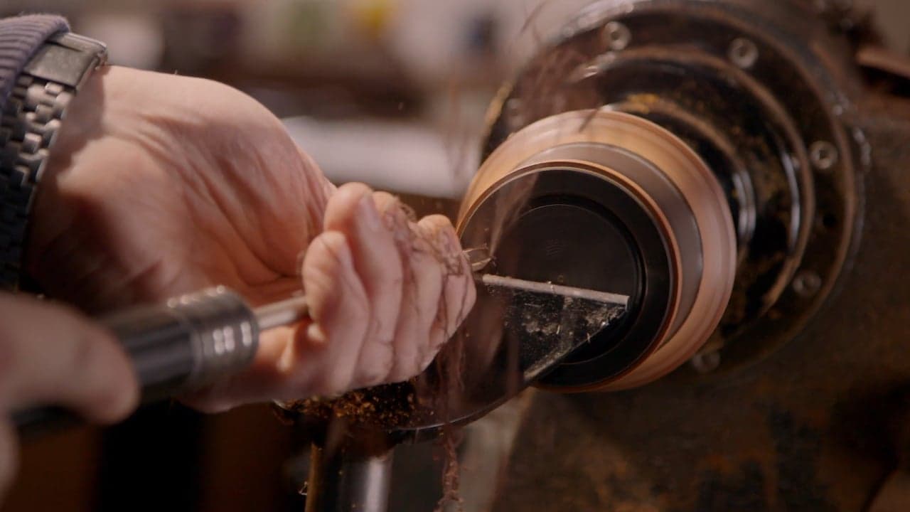 Turns — current film poster showing hands woodturning at a lathe