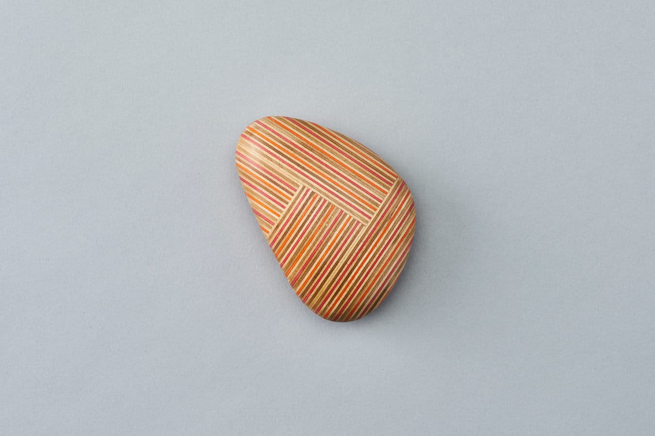 Koishi triangular red/orange paperweight by DRILL DESIGN