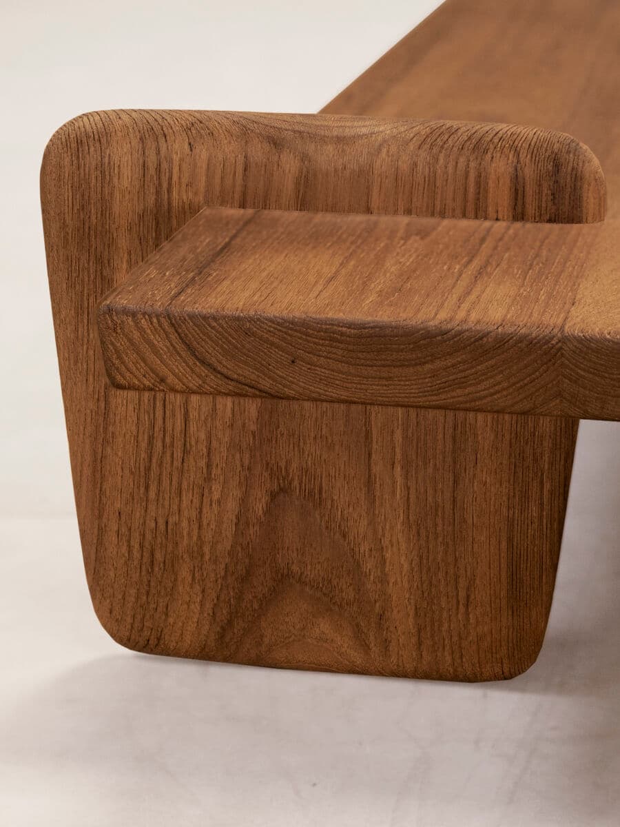 A separate close view of the x+l 01 Coffee Table’s projecting teak leg and textured tabletop