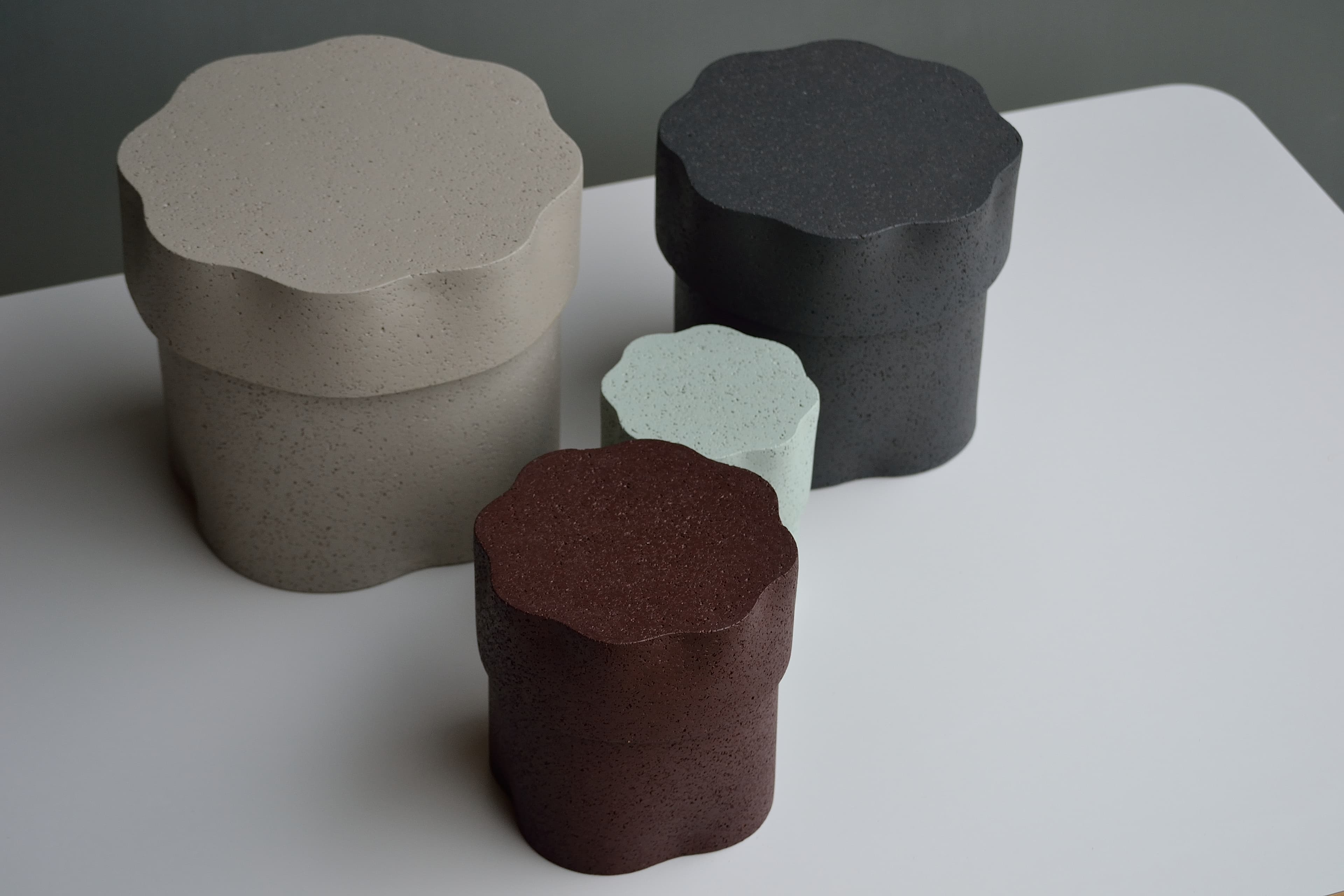 Jig containers viewed from above to show their irregular scalloped lids