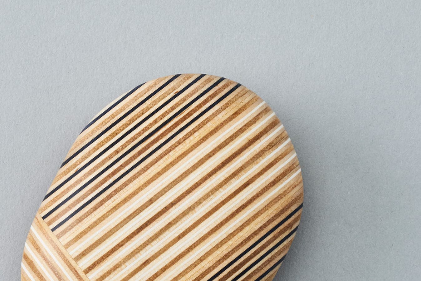Koishi Paper-Wood detail, showing the laminated stripes and patchwork join