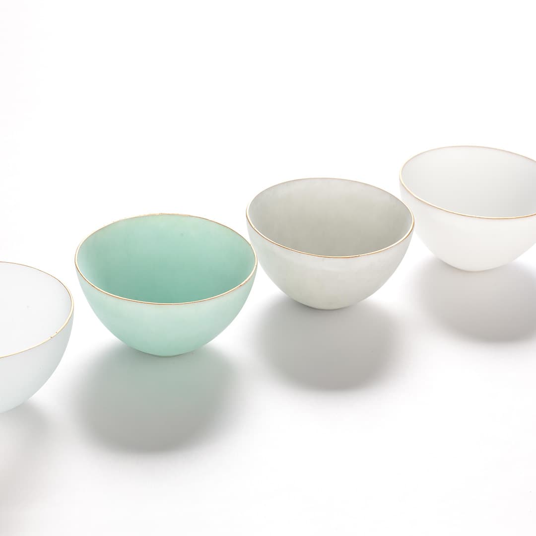 Softly tinted, gold-rimmed glass bowls by Saki Fujimoto