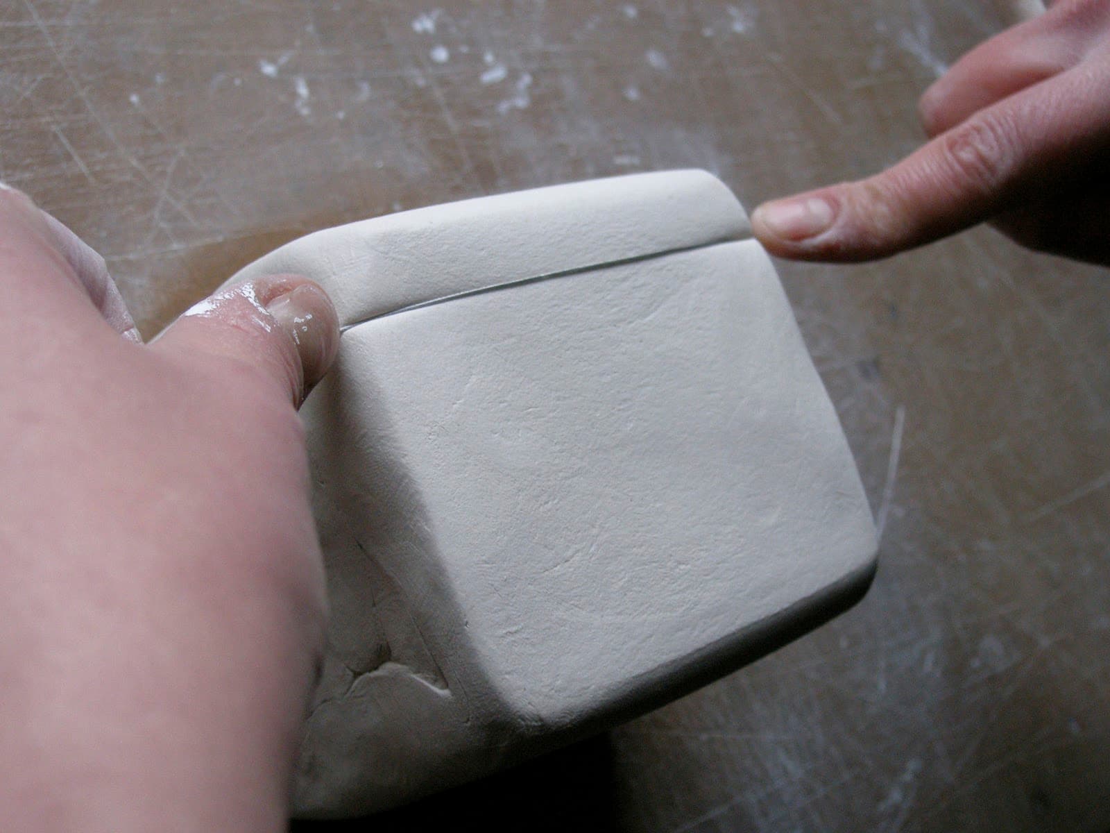 Justine Allison: slicing porcelain clay in the studio. Photograph by Toril Brancher.