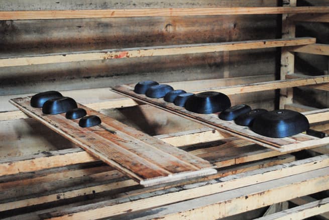 Lacquered-paper containers and lids drying on wooden racks