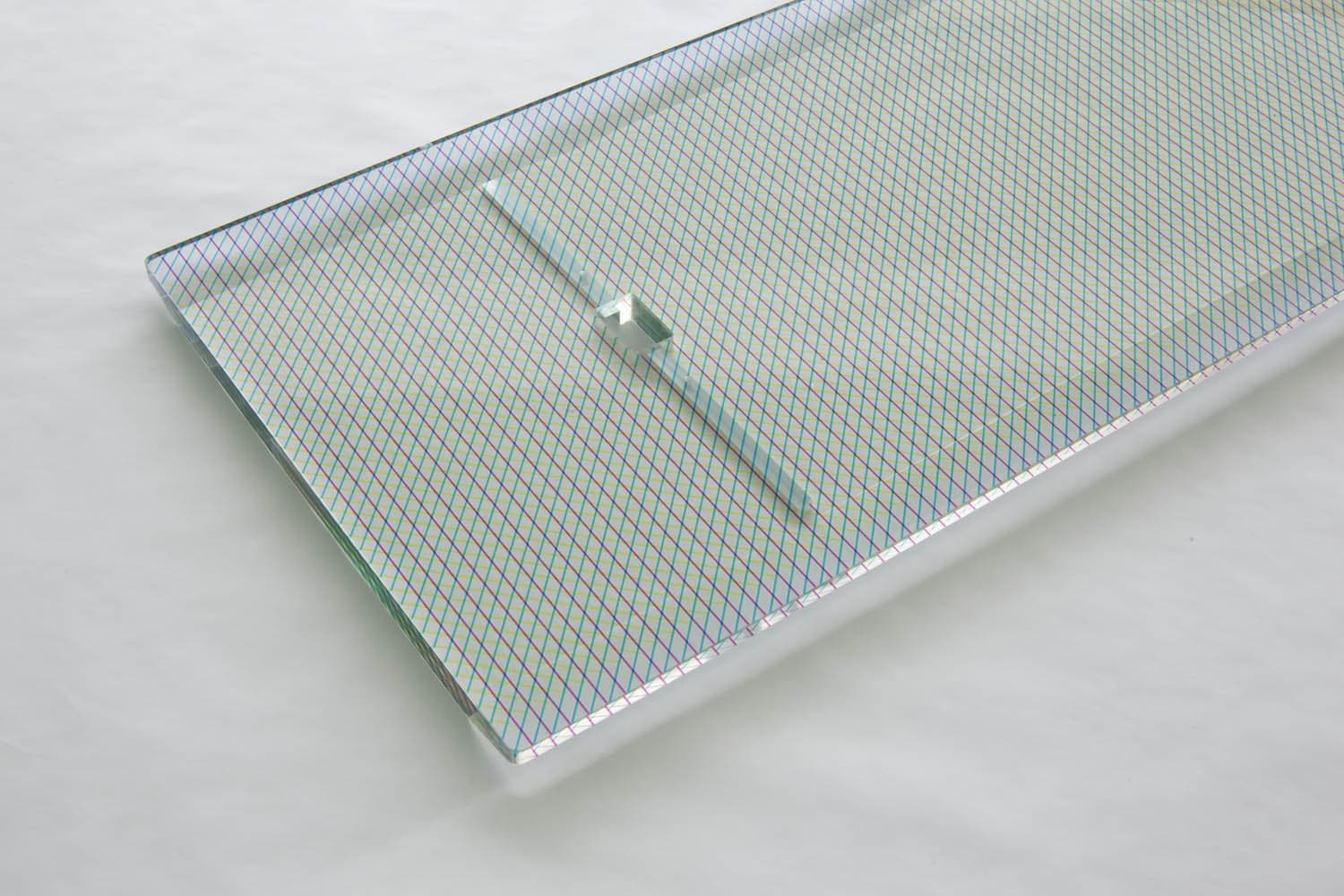 Patterned transparent shelf panel with its square connection opening.