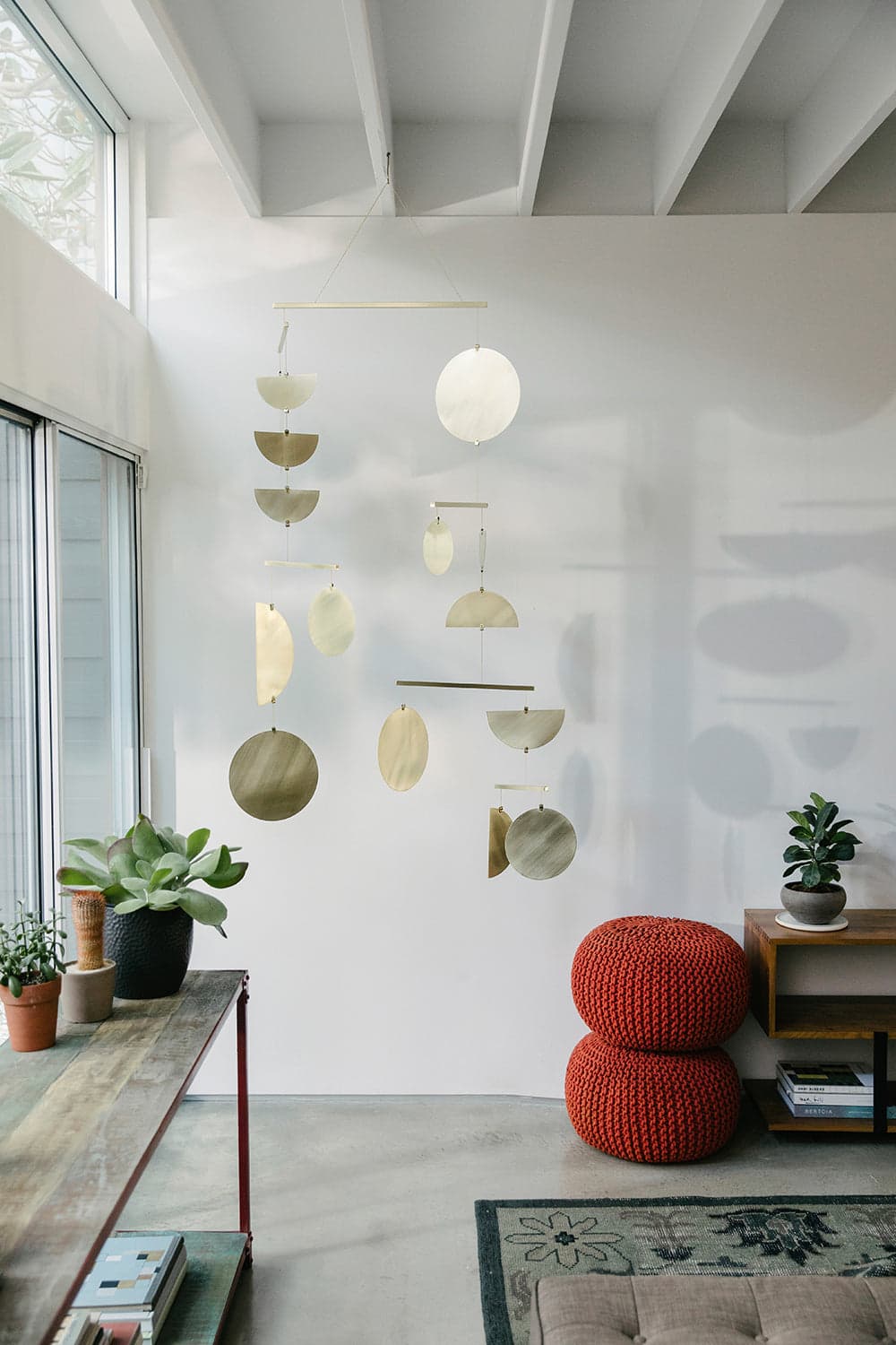 Continuum brass mobile by Corie Humble for Circle & Line, fully suspended with circular and semicircular brass shapes.