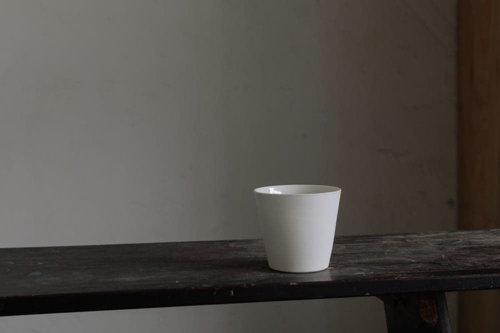 Sue Paraskeva, cream porcelain straight beaker; current collection photograph