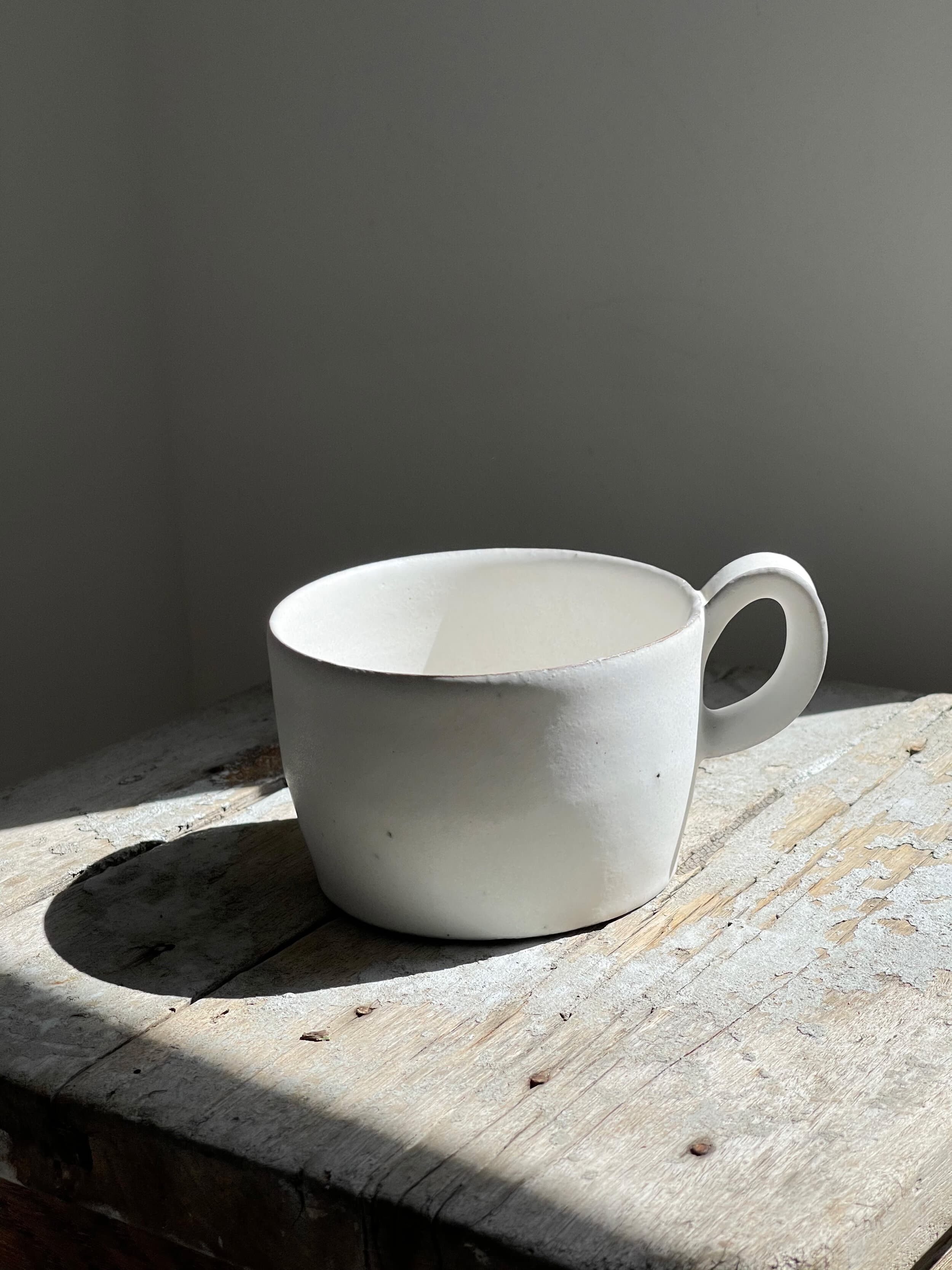 White-slip handled ceramic cup by Makoto Asebi.