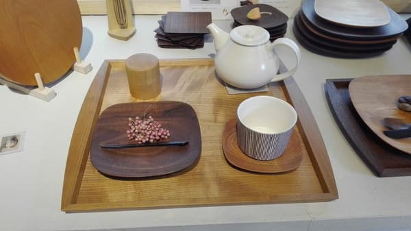 Studio KUKU wooden tray, plates and tableware displayed with ceramic tea vessels during a 2015 studio visit.