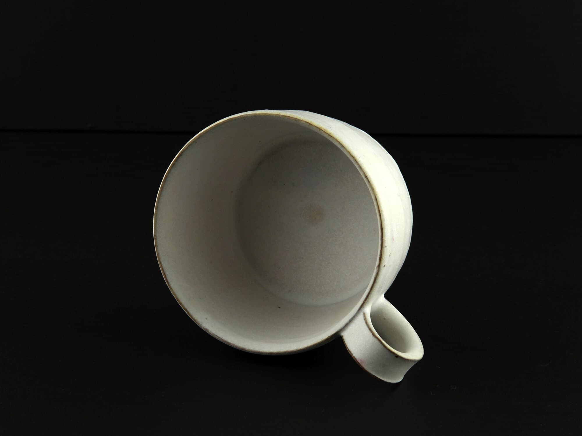 White-slip handled ceramic cup by Makoto Asebi.