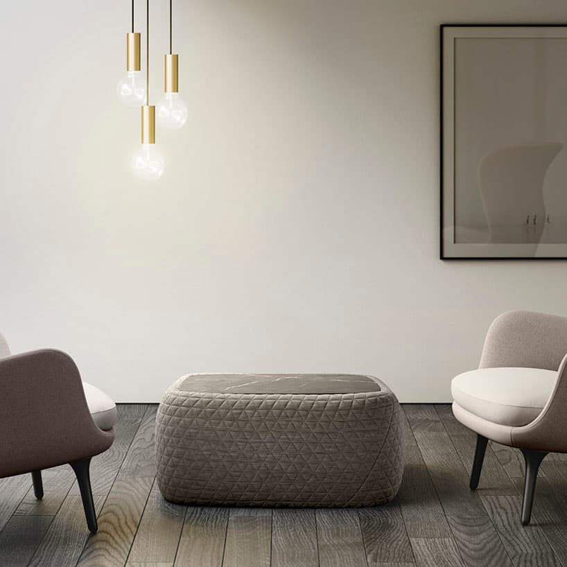Retegui Bigun coffee table with a gray marble top and padded fabric base in a living-room setting.