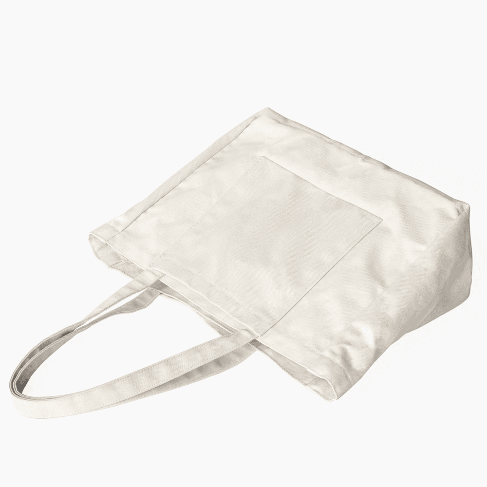 MAKR’s natural-coloured canvas Offset Tote, with long handles and an integrated exterior pocket.