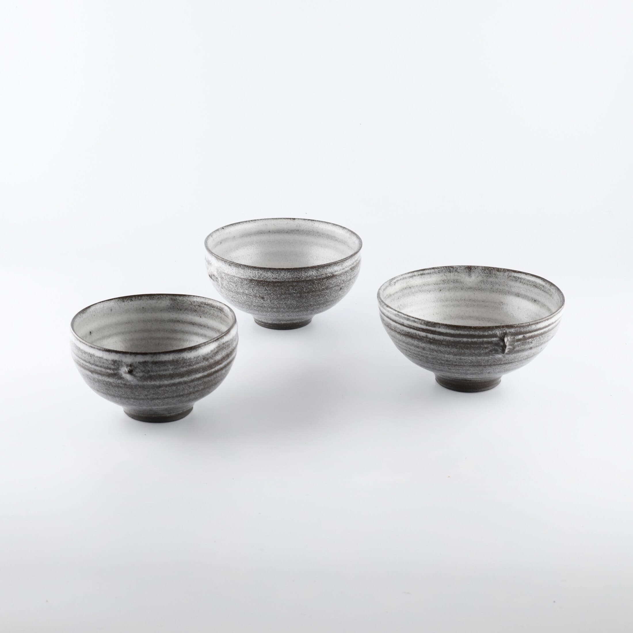 Three simple grey and white ceramic White Birch bowls by Hyejeong Kim.