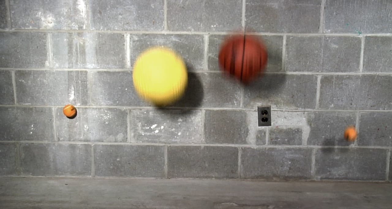 Gravity (2009): suspended falling objects against a block wall