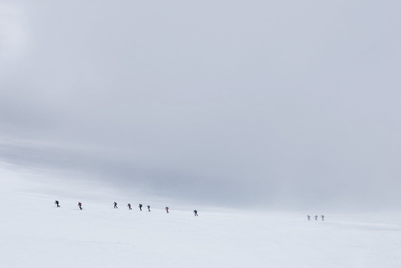 Playground: distant ski mountaineers in a white landscape