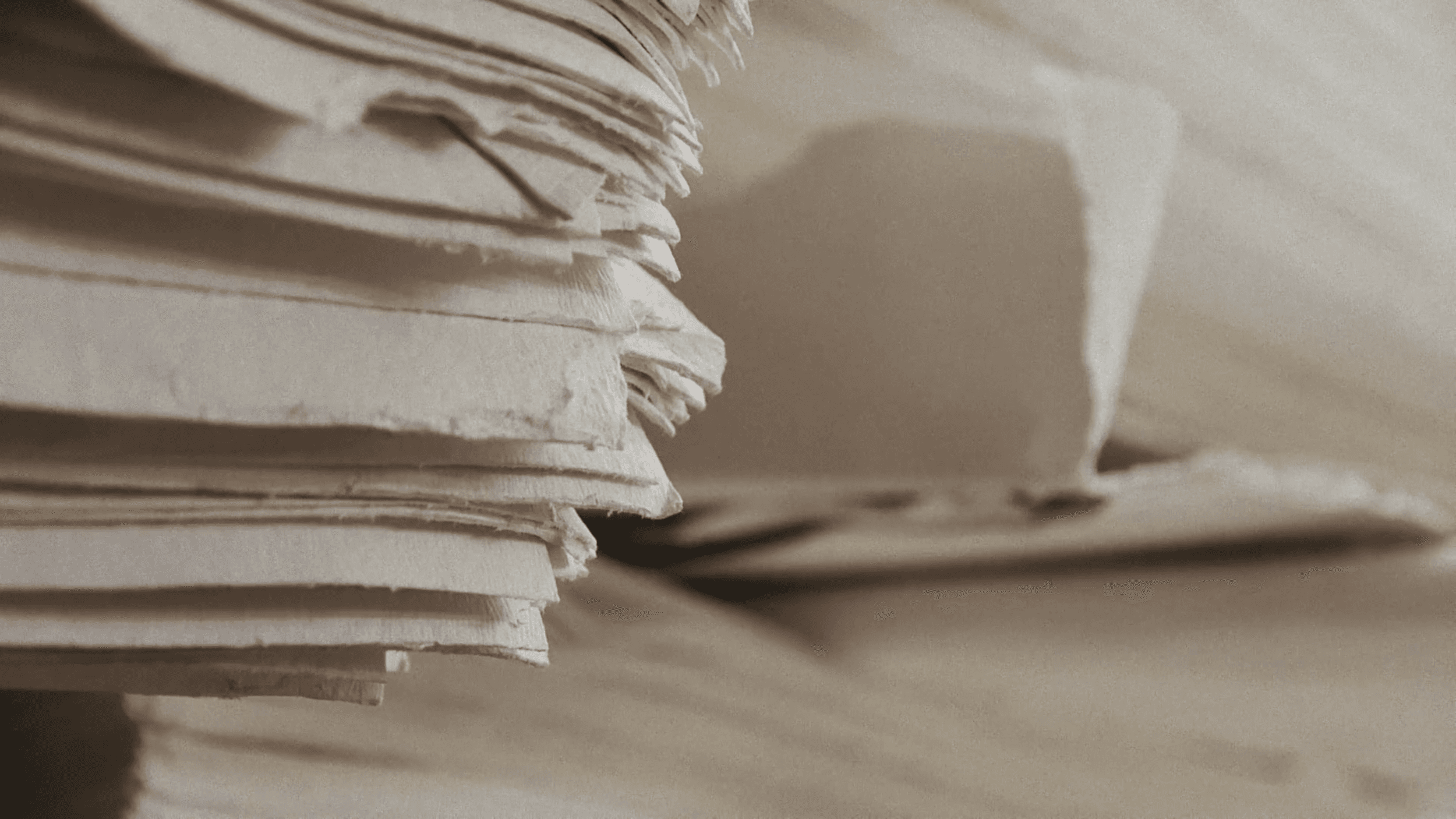Stacked handmade paper sheets, a detail from The Papermaker