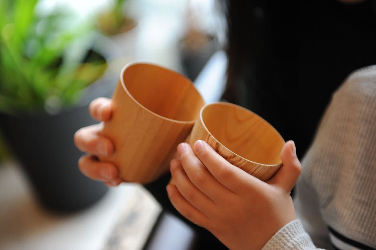Shirasagi Woodwork thin turned wooden cups held in hands