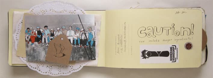 An open notebook spread combines an illustrated group clipping and paper cutouts on the left with hand-drawn Caution lettering and a graphic sticker on the right.
