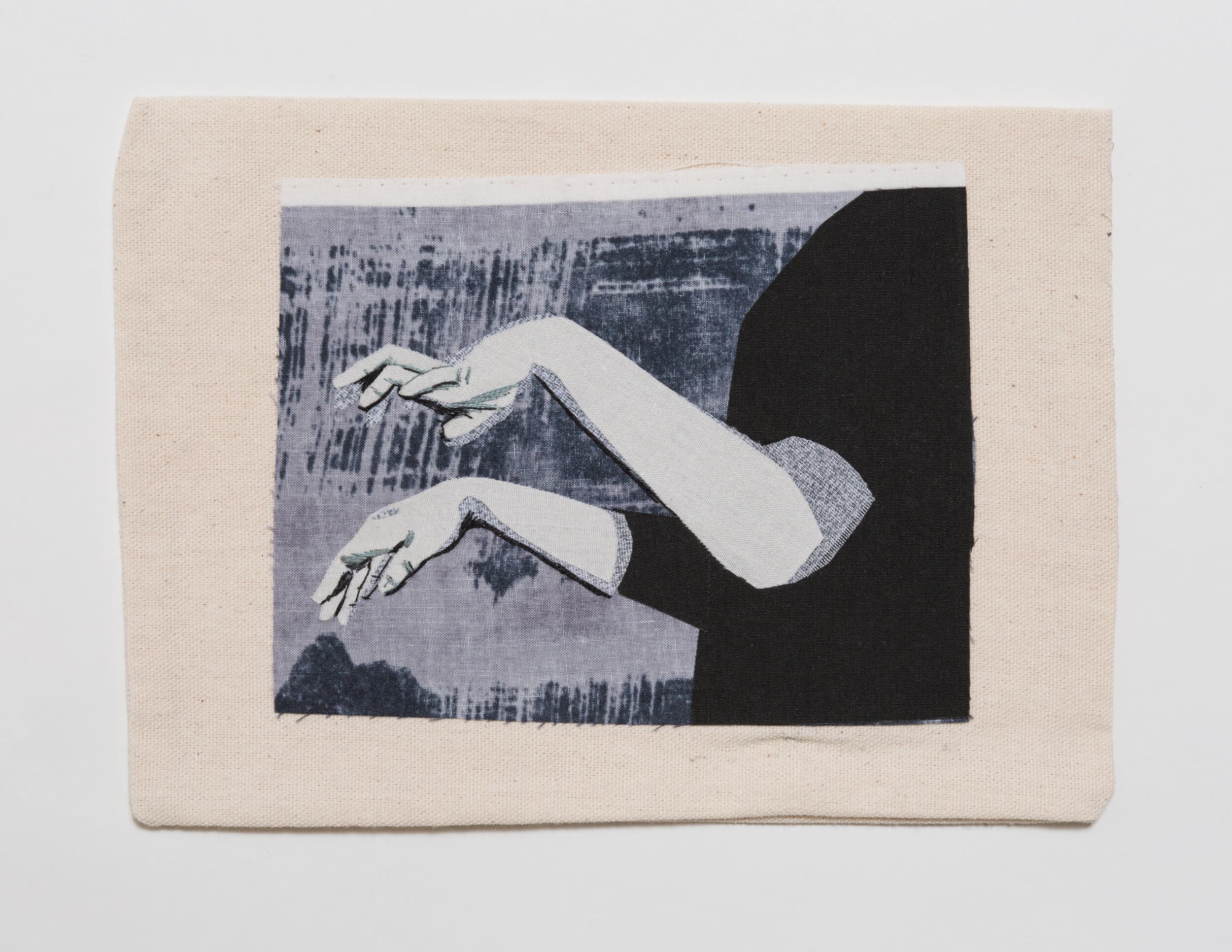 A rectangular fabric artwork with a pale border and layered black-and-white arms and hands, with visible stitched lines around the fingers.
