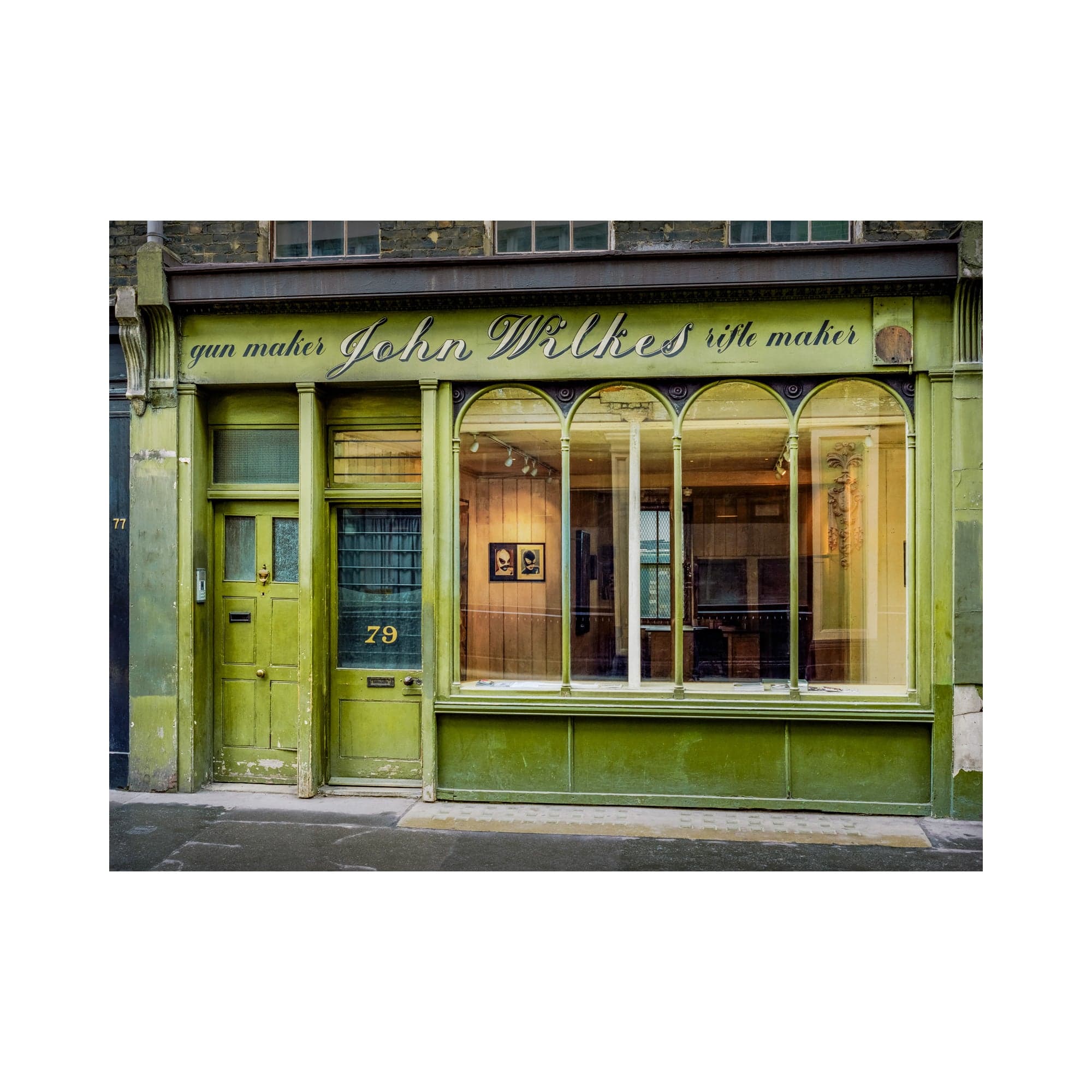 The weathered green John Wilkes shopfront at 79 Beak Street, Soho, with arched display windows and peeling paint.