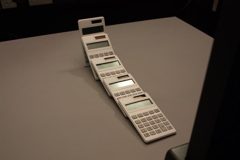 Production photograph for I Am Not An Artist by Johnny Kelly and Matthew Cooper: arranged calculators.
