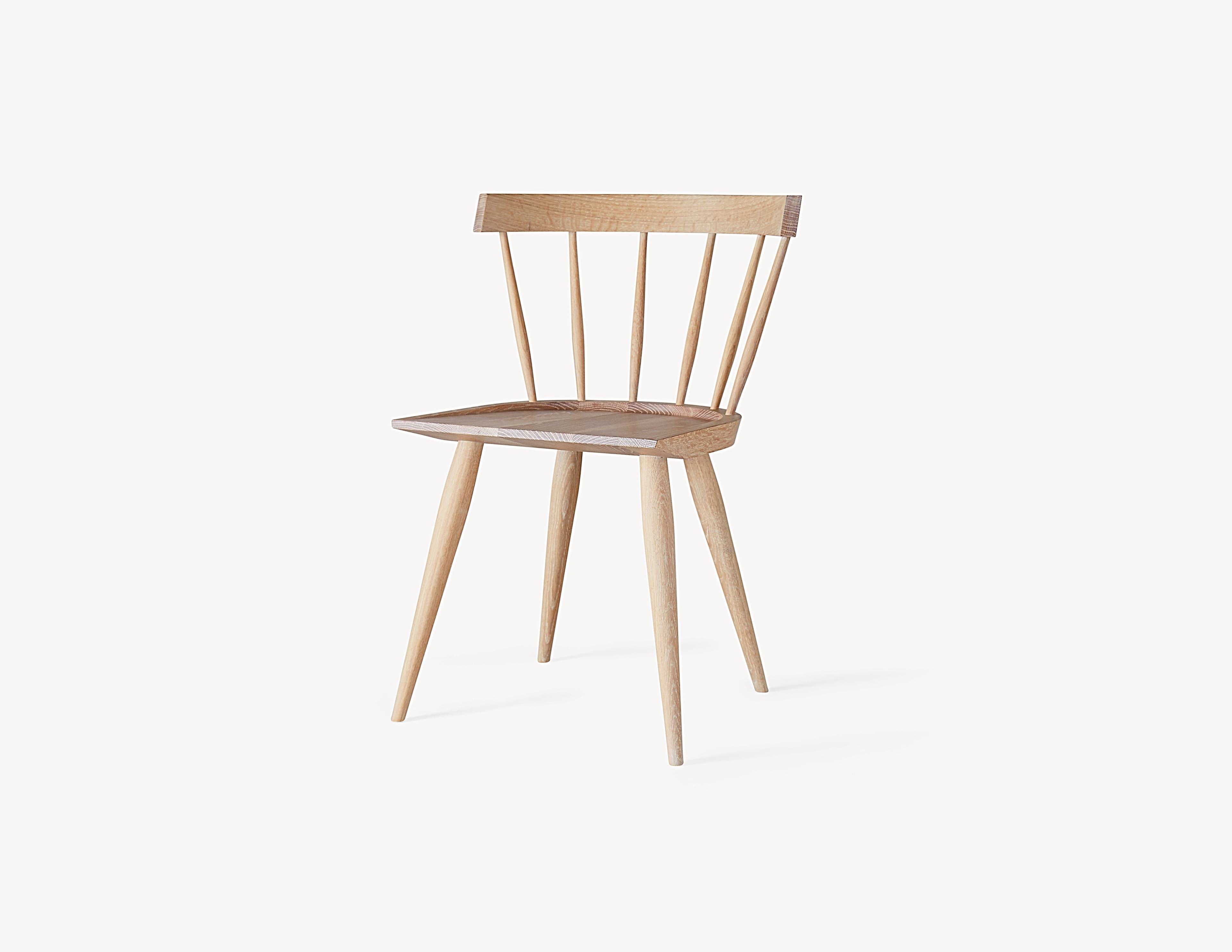 Coolican & Company Edwin Chair in white oak, showing its solid seat and tapered legs.