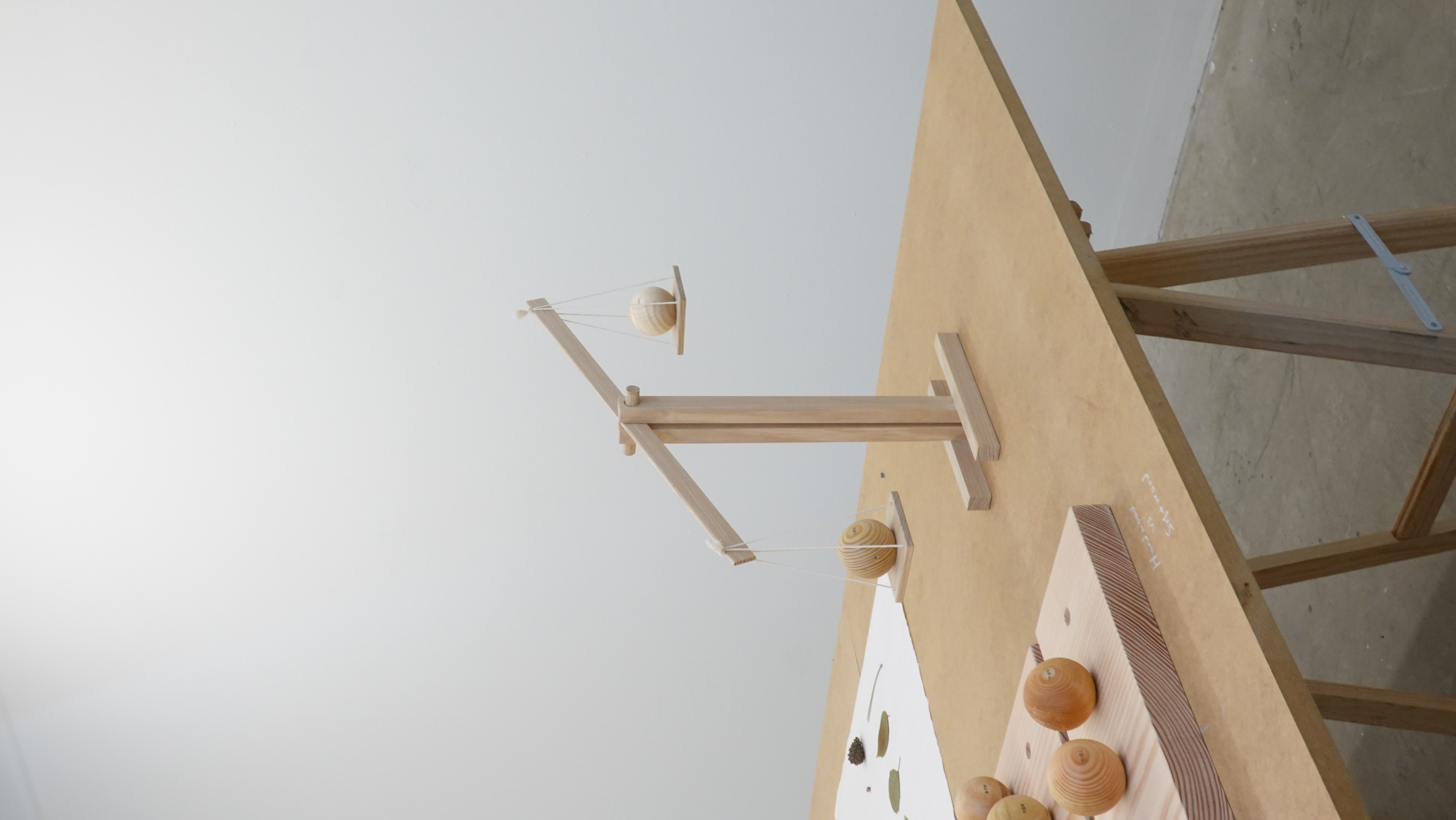 A balance and small timber objects used to investigate the weight of wood.
